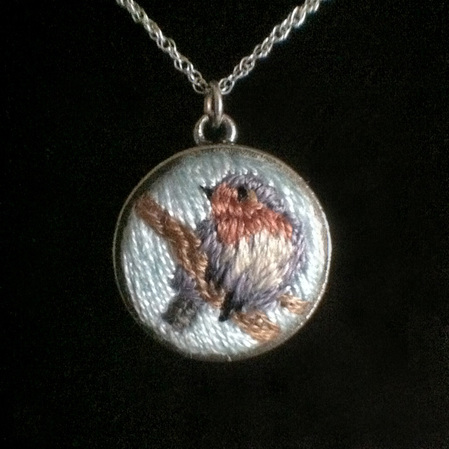hand embroidered image in small pendent