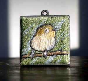 hand embroidered image in small pendent